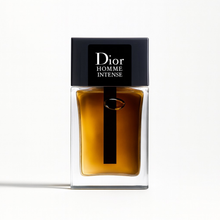 Dior Homme Intense Eau de Parfum bottle with amber liquid and black cap on a white background
