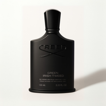 Creed Green Irish Tweed matte black perfume bottle with shadow on a plain white background