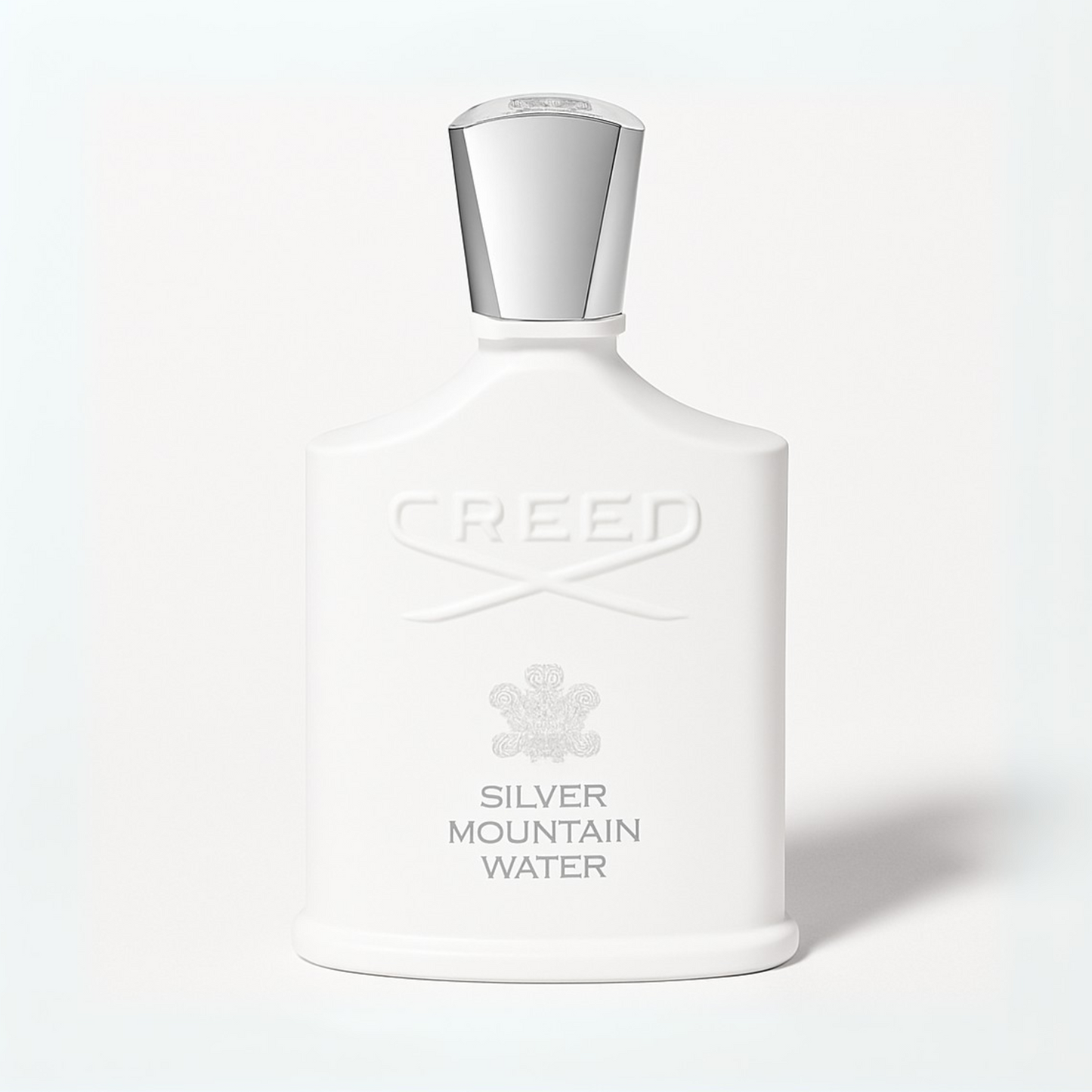 Creed Silver Mountain Water perfume bottle with silver cap and white bottle on a plain white background