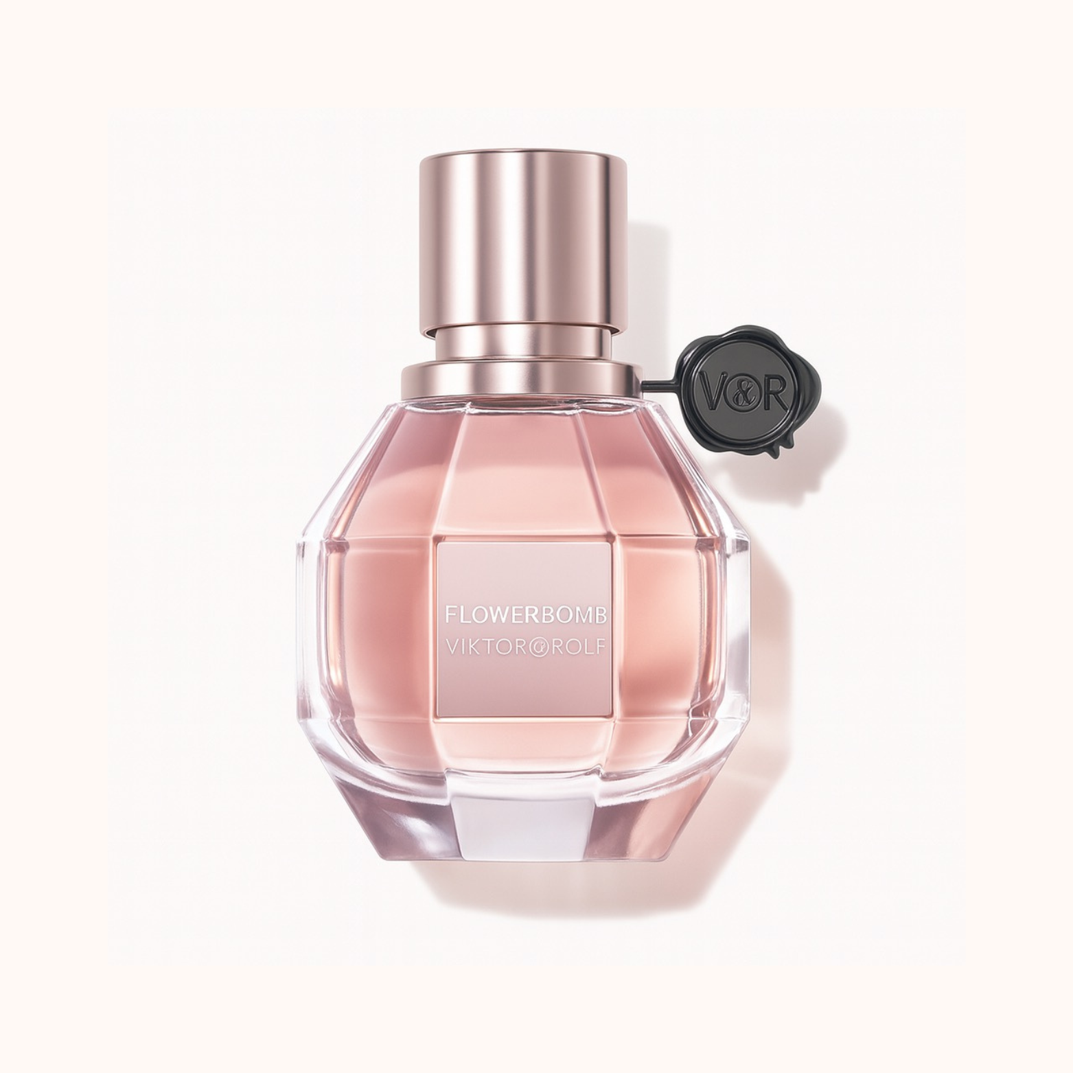 Flowerbomb Eau de Parfum by Viktor & Rolf pink fragrance bottle with rose gold cap on a white background