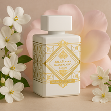 Lattafa Badee Al Oud Honor and Glory bottle surrounded by jasmine and rose petals on a soft beige background