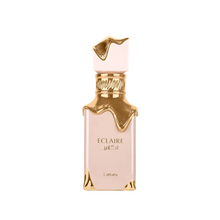 Lattafa Eclaire Eau de Parfum bottle with gold drip design, isolated on white background