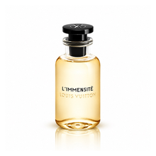 Louis Vuitton L’Immensité Eau de Parfum men's fragrance bottle with translucent golden amber glass, glossy black cap and silver LV logo on white background