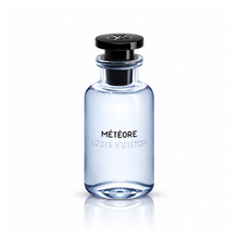 Louis Vuitton Météore Eau de Parfum men's fragrance bottle with translucent pale blue glass, glossy black cap and silver LV logo on white background