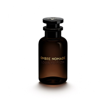 Louis Vuitton Ombre Nomade perfume bottle with black cap and amber-brown glass on a clean white background.