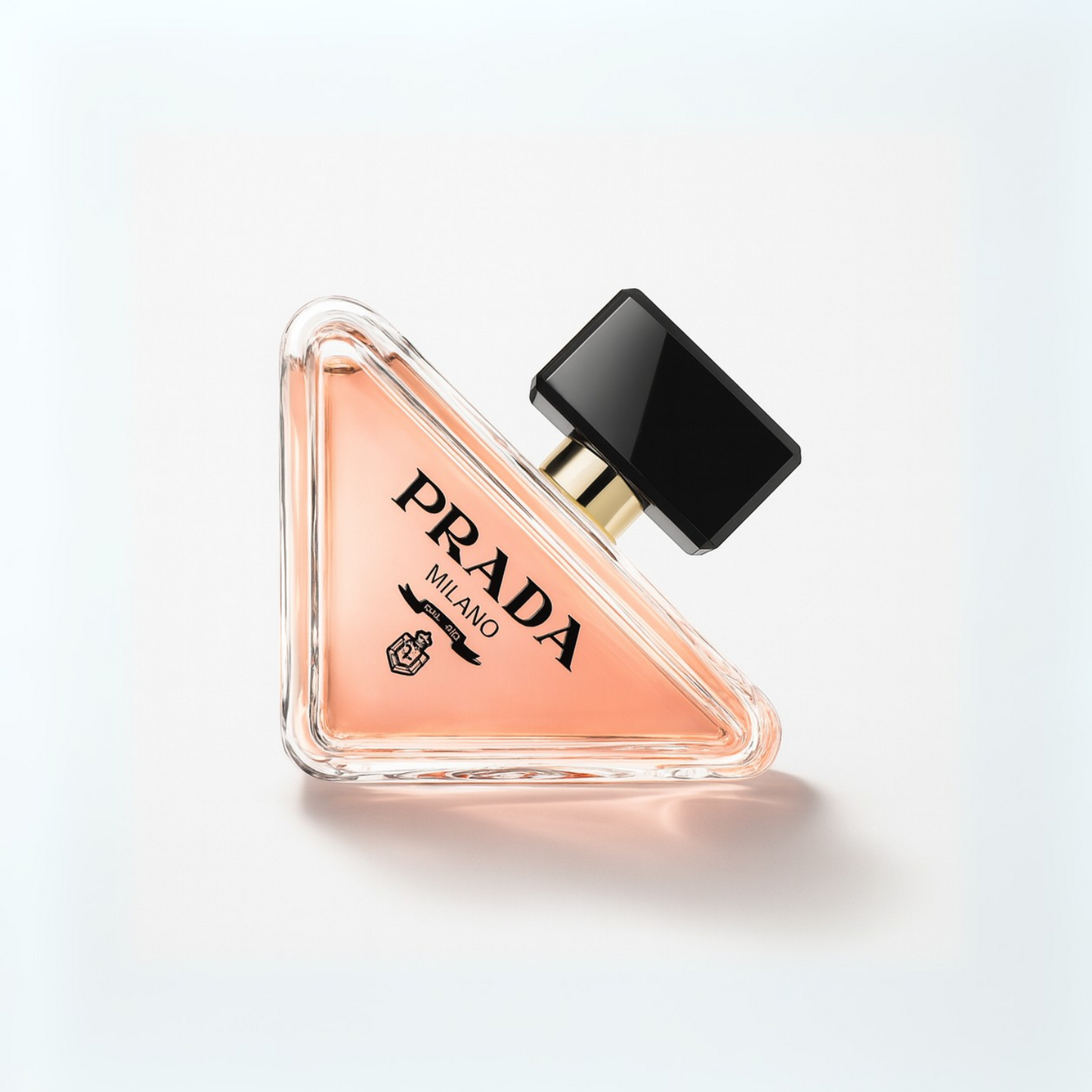 Prada Paradoxe Eau de Parfum triangular perfume bottle with black cap displayed on a white background