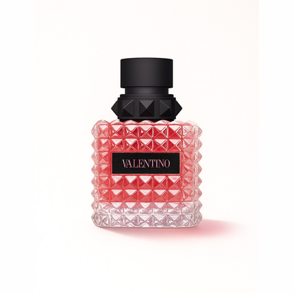 Valentino Donna Born In Roma Eau de Parfum bottle on white background showcasing its pink stud-patterned glass design and black cap with signature Valentino logo.