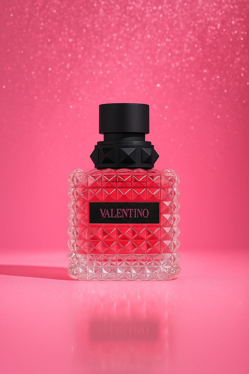 Valentino Donna Born In Roma EDP bottle displayed against a sparkling pink background, highlighting its luxurious crystal-cut texture and modern feminine style