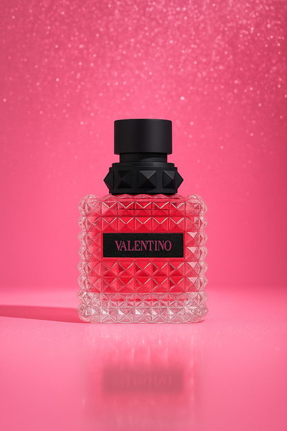 Valentino Donna Born In Roma EDP bottle displayed against a sparkling pink background, highlighting its luxurious crystal-cut texture and modern feminine style