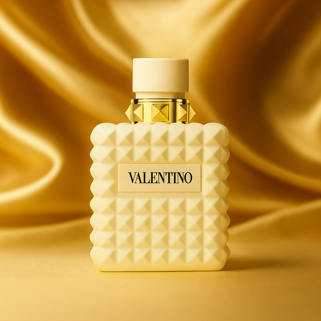 Valentino Donna Born in Roma Ivory perfume bottle with ivory studded design and gold accents displayed on gold satin fabric background
