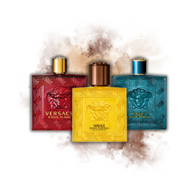 Versace Eros Flame, Eros Energy, and Eros Eau de Parfum bottles with a dramatic amber and gold lighting backdrop