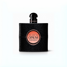 Yves Saint Laurent Black Opium Eau de Parfum black glitter bottle with pink center label on a plain white background